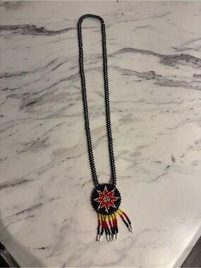 Vintage Indigenous beaded necklace with medallion Native American artwork